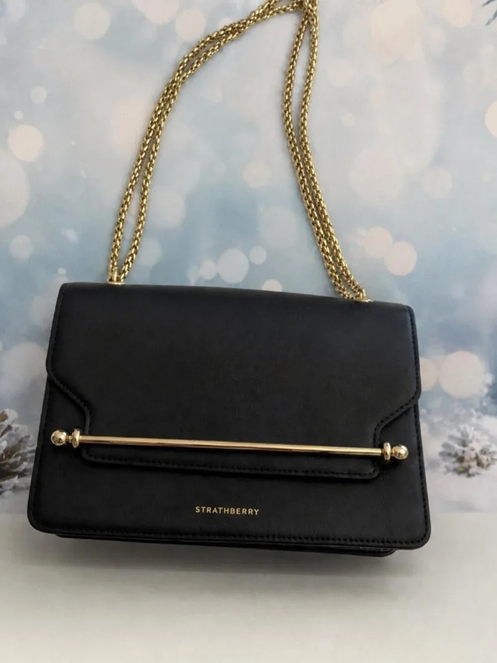 Strathberry Black Leather Shoulder Bag with Gold Bar and Chain